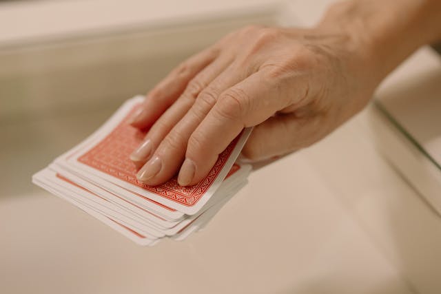 Person Picking A Gaming Card